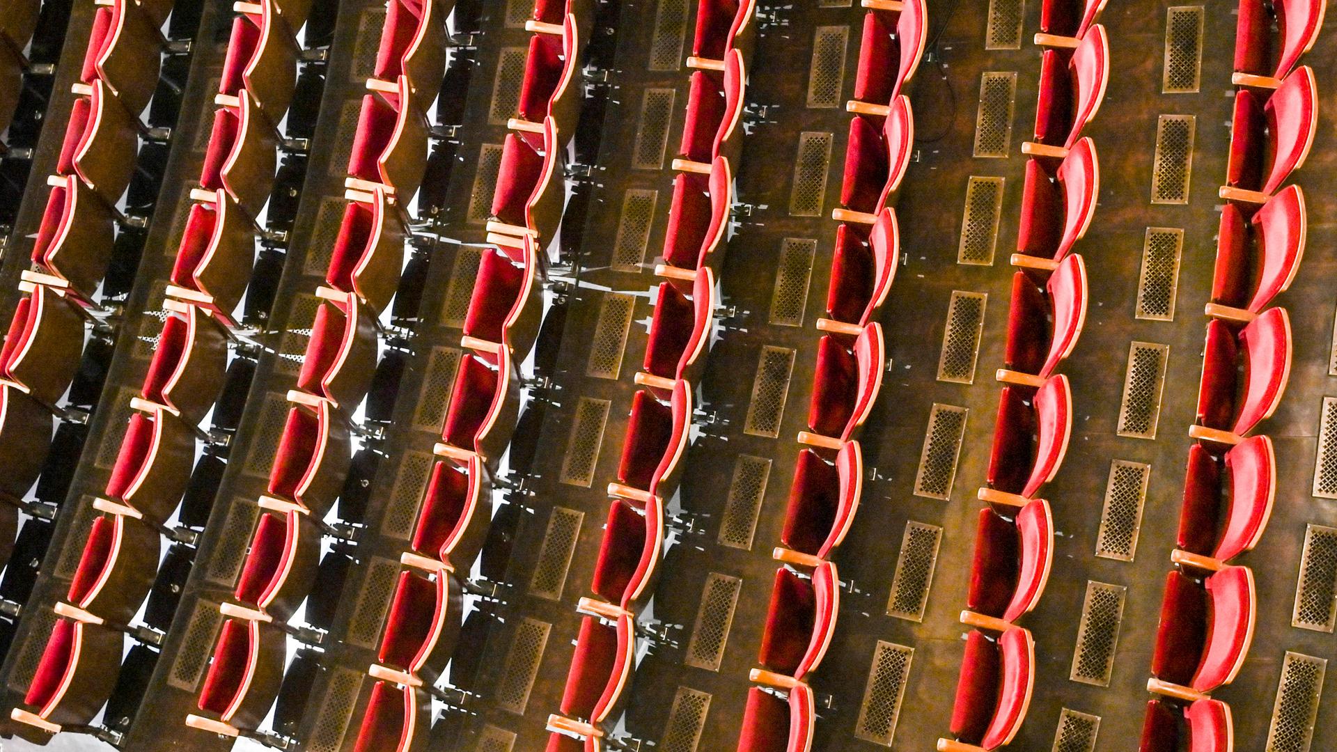 Blick in den leeren Zuschauersaal eines Theaters.