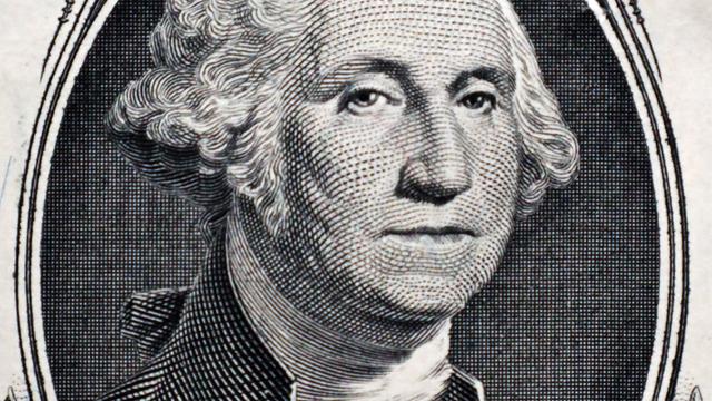 Ausschnitt auf der 1-US-Dollar-Note, auf der ein Porträt von George Washington gedruckt ist. Das Porträt ist umrandet von Ornamenten. Ausschnitt auf der 1-US-Dollar-Note, auf der ein Porträt von George Washington gedruckt ist. Das Porträt ist umrandet von Ornamenten.