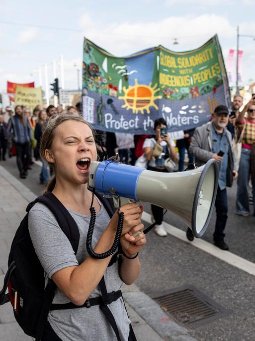 Die schwedische Aktivistin Greta Thunberg ruft während einer Klimademonstration in Stockholm in ein Megafon.