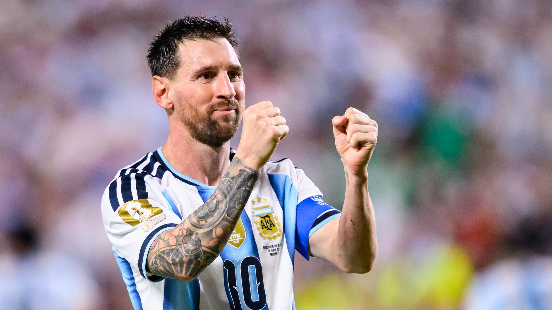 Lionel Messi im Trikot der argentinischen Nationalmannschaft. Er ballt die Fäuste und lächelt. Lionel Messi im Trikot der argentinischen Nationalmannschaft. Er ballt die Fäuste und lächelt.