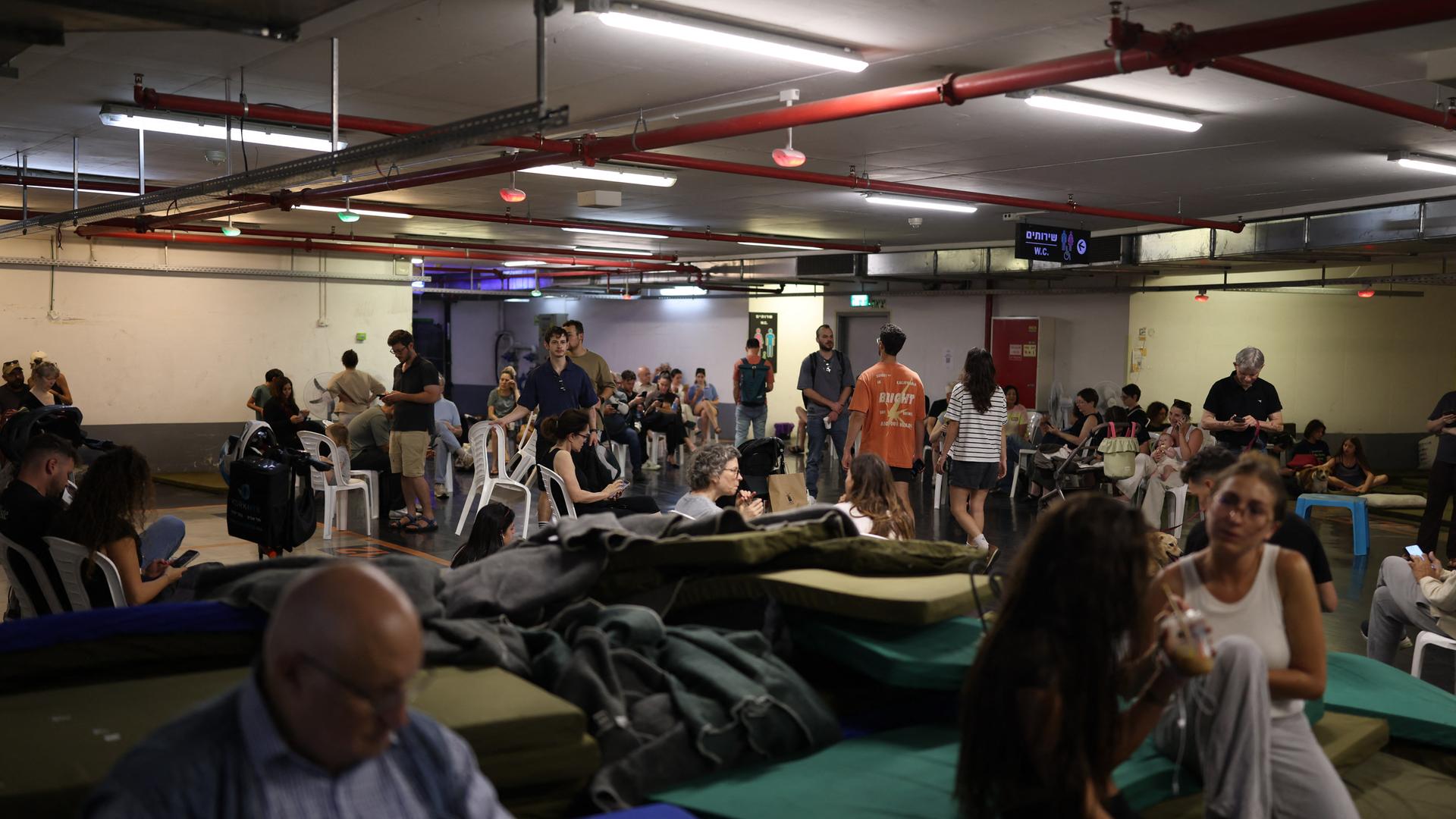 Menschen in Tel Aviv suchen Schutz vor iranischen Angriffen in unterirdischen Räumen.