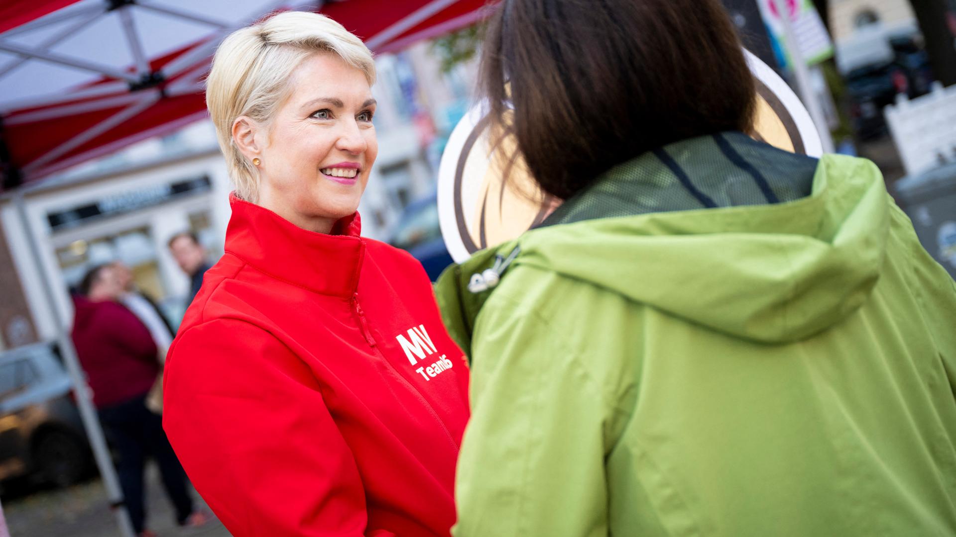 Manuela Schwesig (SPD) an einem Wahlkampfstand im Gespräch mit einer Passantin
