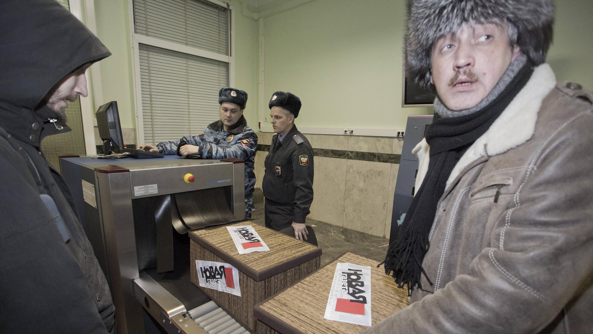 Sergei Sokolow (r), Chefredakteur der Nowaja Gaseta, liefert im Empfangsbüro der Staatsduma Kisten ab.