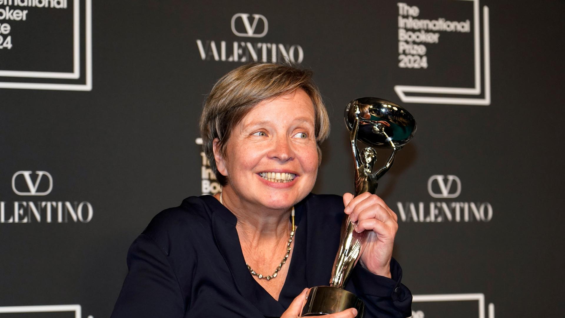 Jenny Erpenbeck, author of 'Kairos', holds the trophy after winning the International Booker Prize, in London, Tuesday, May 21, 2024. (AP Photo/Alberto Pezzali) Jenny Erpenbeck, author of 'Kairos', holds the trophy after winning the International Booker Prize, in London, Tuesday, May 21, 2024. (AP Photo/Alberto Pezzali)