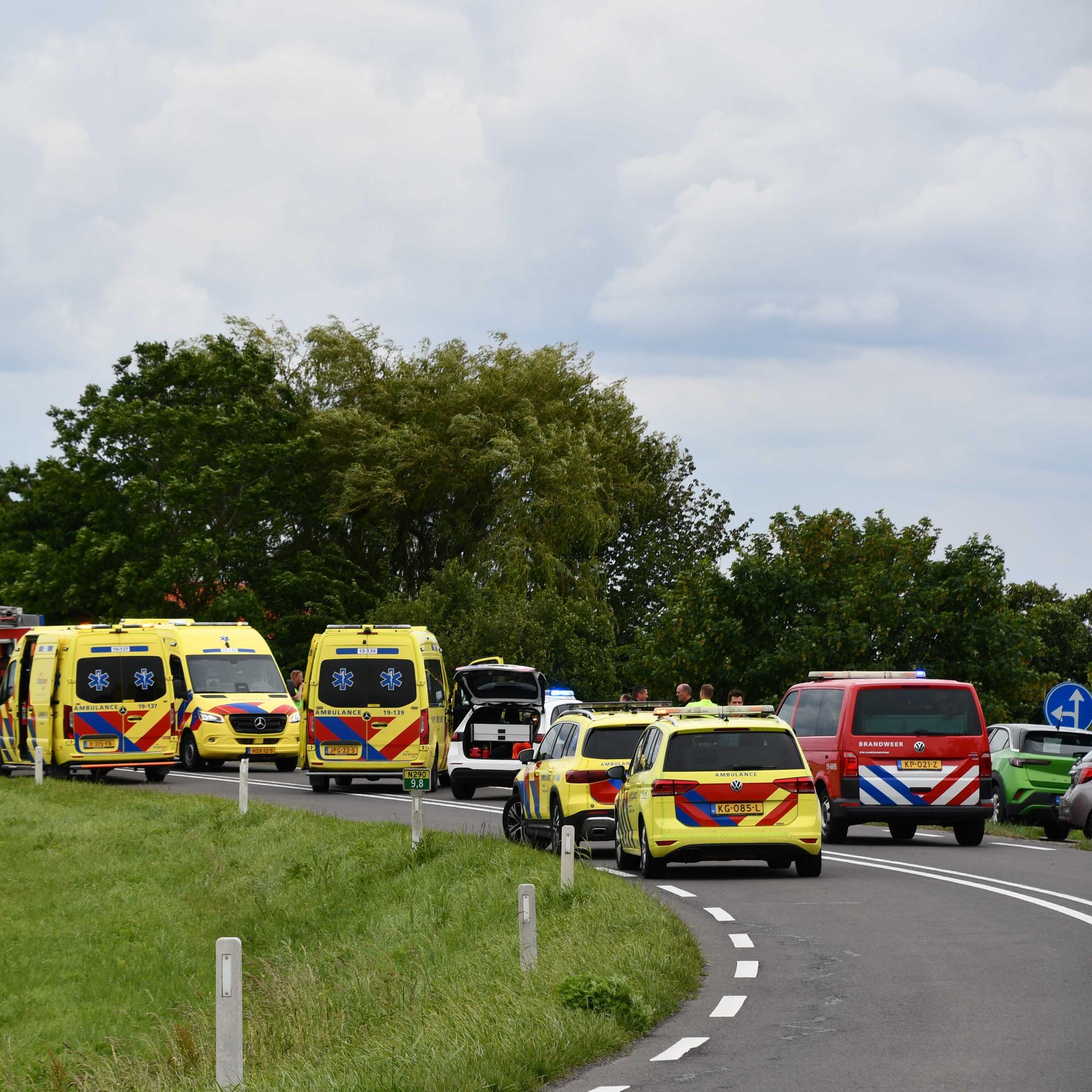 Rettungskräfte sind an einer Straße in den Niederlanden im Einsatz. Feuewehrwagen und Rettungswagen stehen an der Straße.