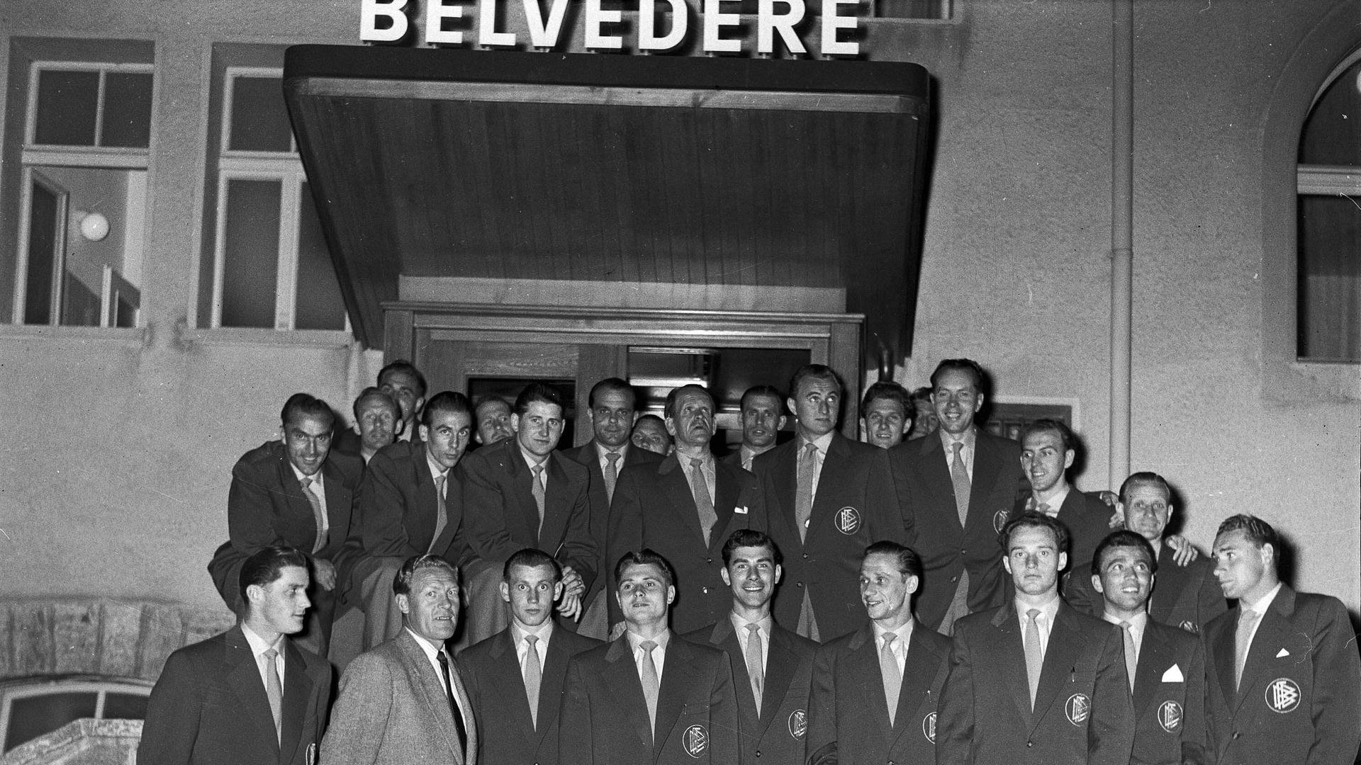 Die deutsche Fussballmannschaft posiert in Zivilkleidung auf einer Treppe vor dem Hotel Belvédère in Spiez.