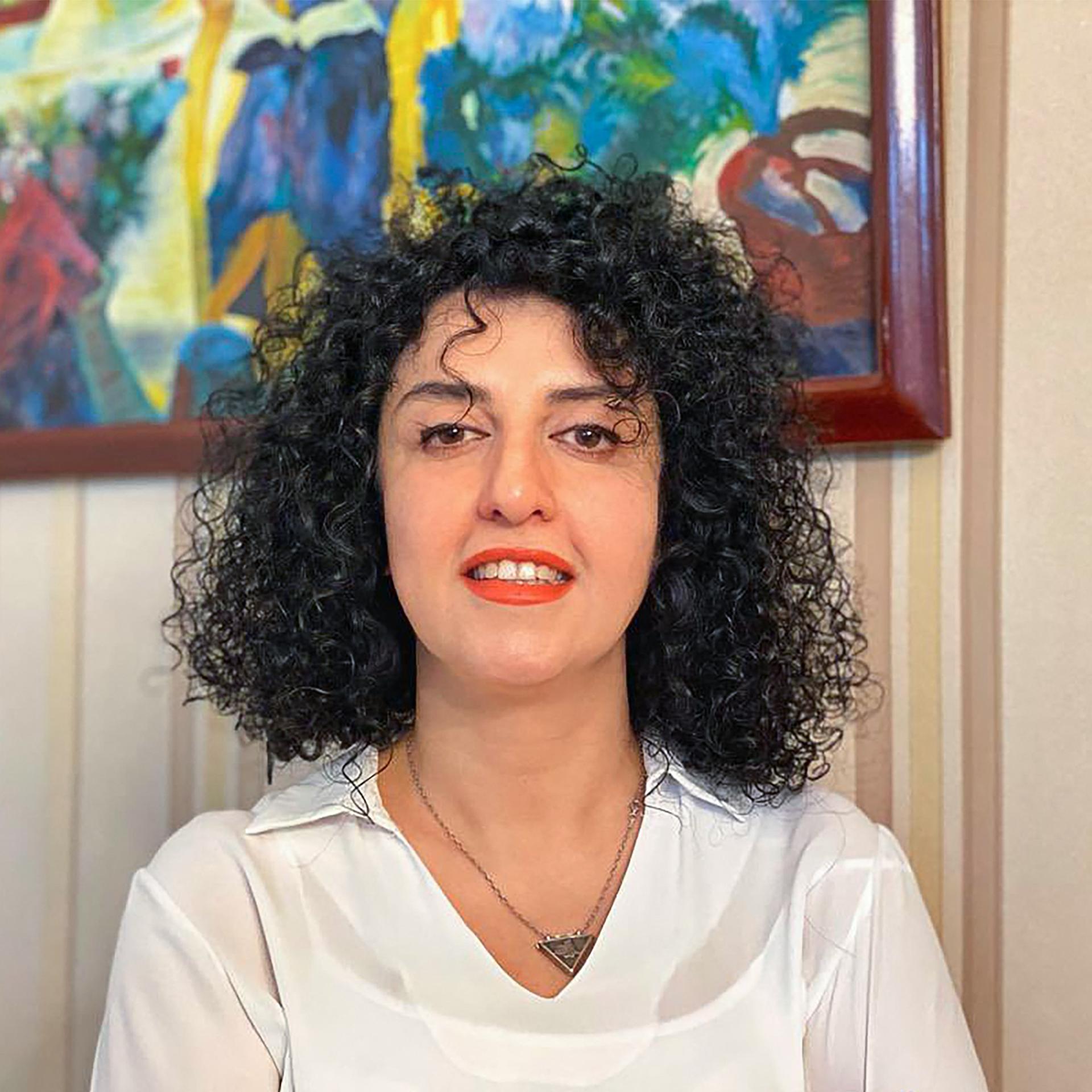 Portrait der Menschenrechtsaktivistin Narges Mohammadi. Sie trägt das Haar offen und schaut direkt in die Kamera. 