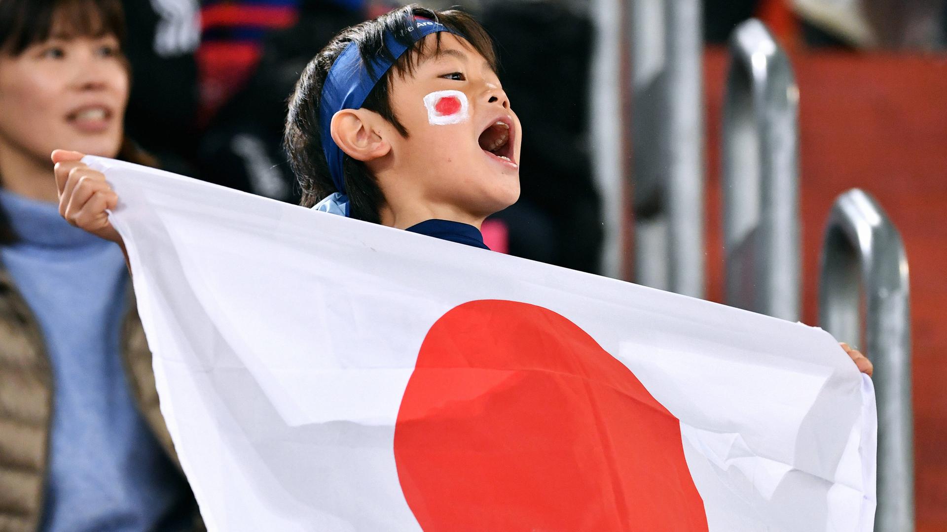 Ein junger Fan feuert die japanische FußballNationalmannschaft an.