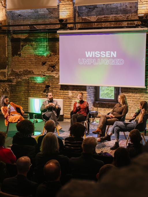 Gäste sitzen bei der Veranstaltung "Wissen unplugged" auf der Bühne