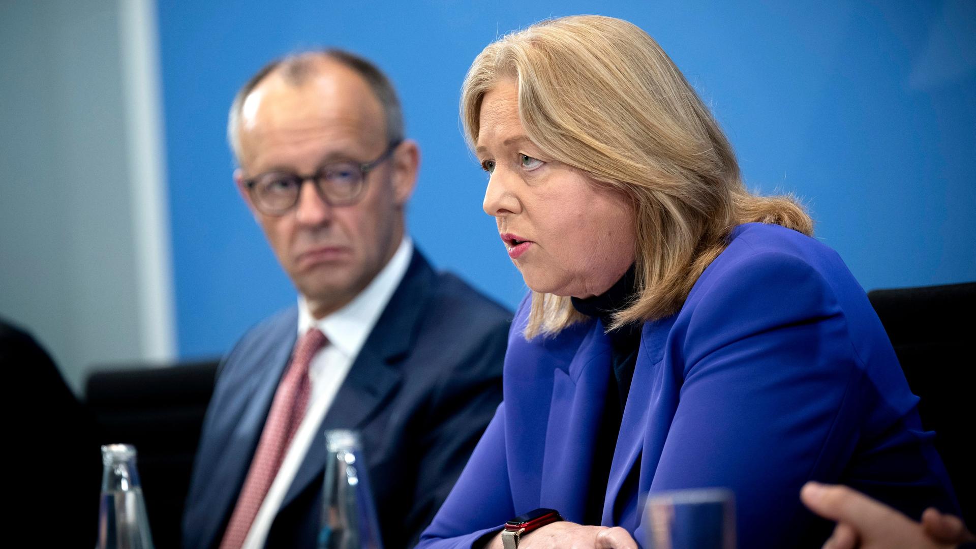 Friedrich Merz und Bärbel Bas sitzen nebeneinander in der Bundesprässekonferenz; Bas spricht ins Mikrofon. Friedrich Merz und Bärbel Bas sitzen nebeneinander in der Bundesprässekonferenz; Bas spricht ins Mikrofon.