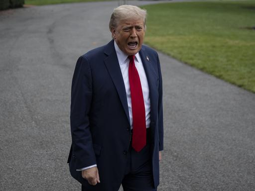 Donald Trump steht auf einem Weg vor dem Weißen Haus und schreit in die Kamera