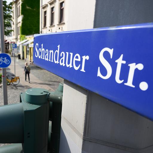 Ein Straßenschild "Schandauer Straße" ist in Dresden-Striesen über einer Ampel montiert. 