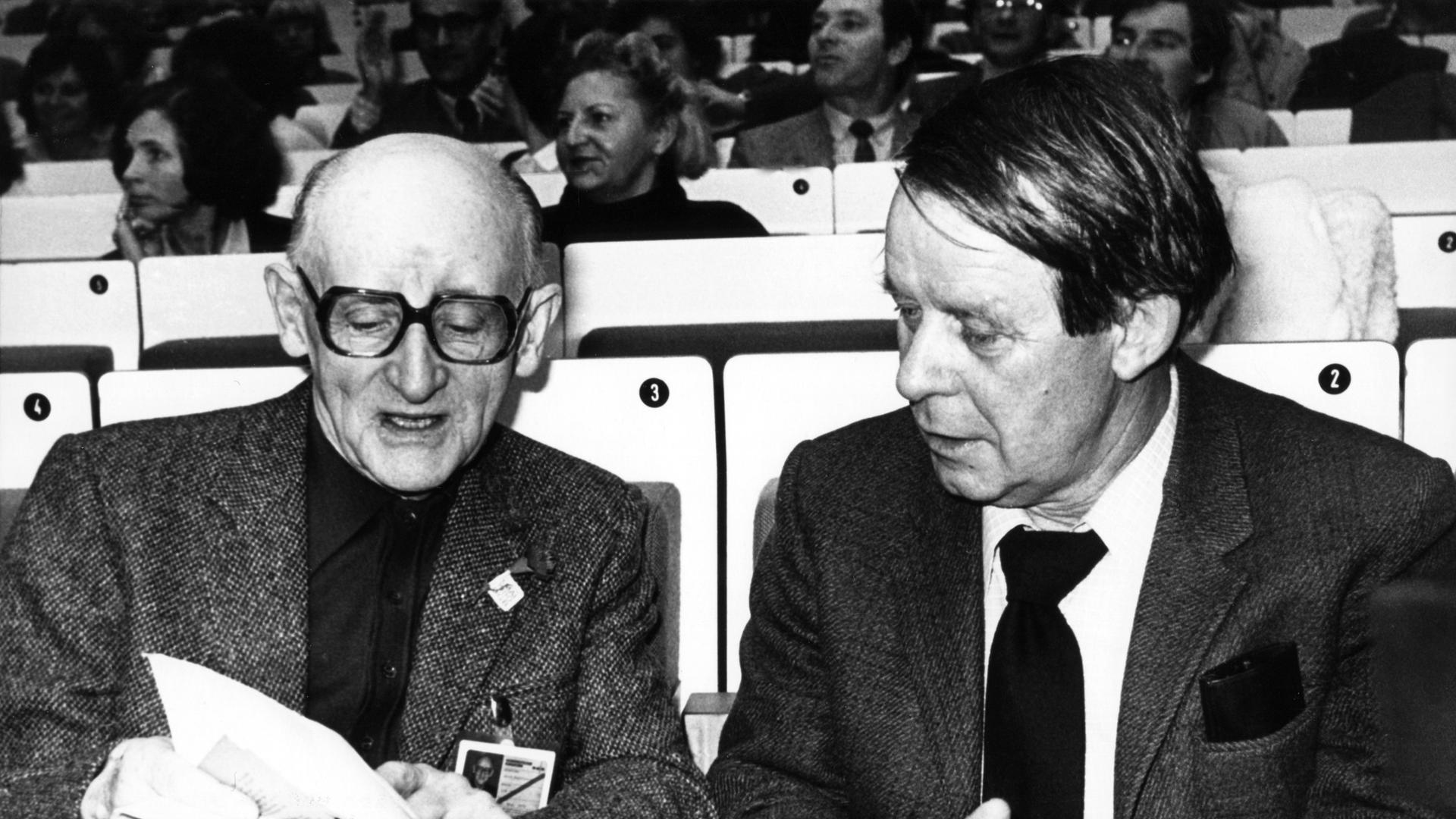 Der Schriftsteller Siegfried Lenz (rechts ) und der Journalist und Autor Axel Eggebrecht am 19. Dezember 1979 im Congress Centrum Hamburg bei einer Solidaritätskundgebung des DGB zur Erhaltung des NDR.