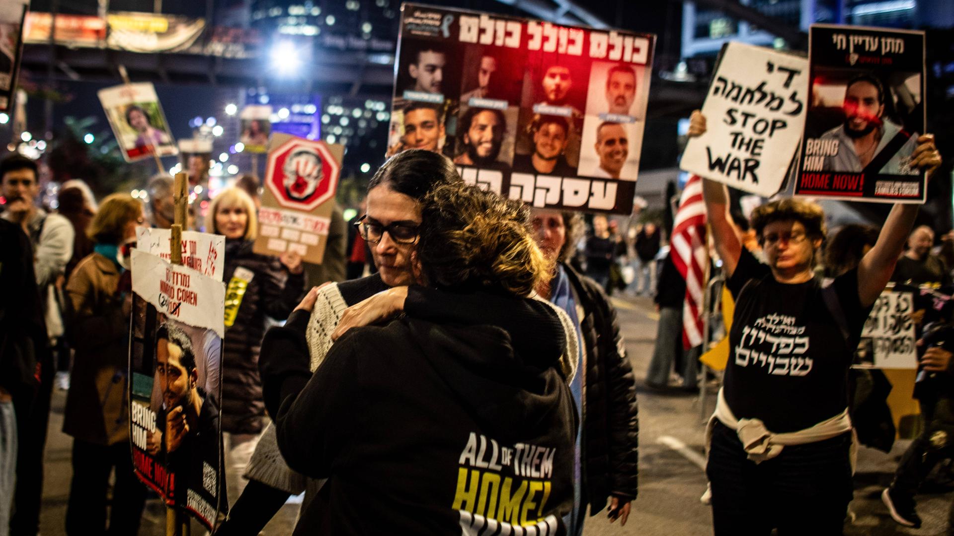 January 15, 2025, Tel Aviv, Israel: A woman holds a placard of Israeli Hostage Nimrod Cohen as she hugs a youth during a protest in Tel Aviv calling for the release of all 98 hostages.