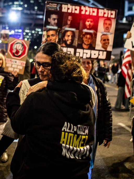 January 15, 2025, Tel Aviv, Israel: A woman holds a placard of Israeli Hostage Nimrod Cohen as she hugs a youth during a protest in Tel Aviv calling for the release of all 98 hostages.