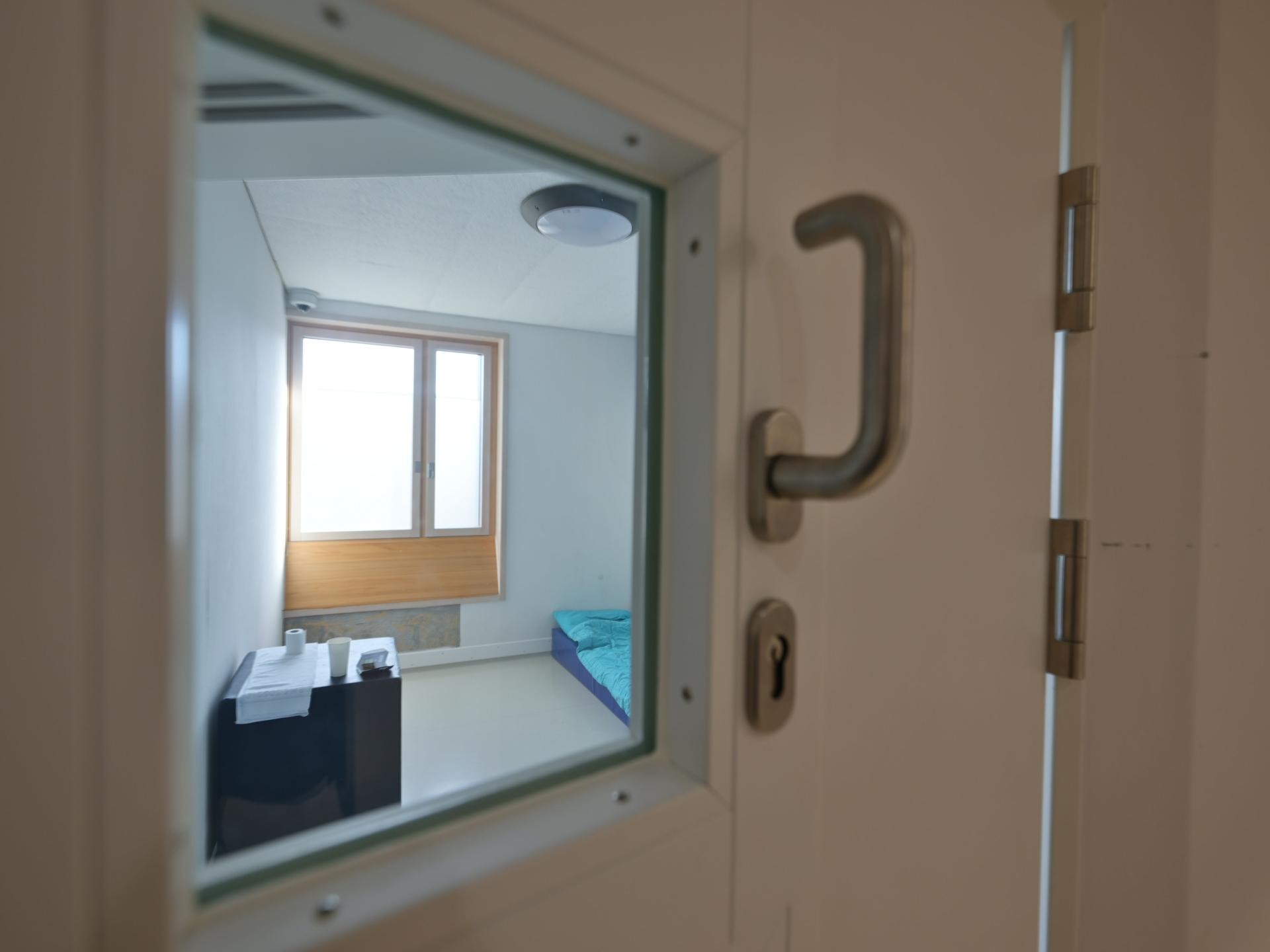 Ein Intensiv-Zimmer ist im Zentrum für Psychiatrie in Weißenau (ZfP) menschenleer. Die Tapete wurde teils abgerissen. Der Blick ins Zimmer ist durch die Sichtscheibe in der Tür möglich.
