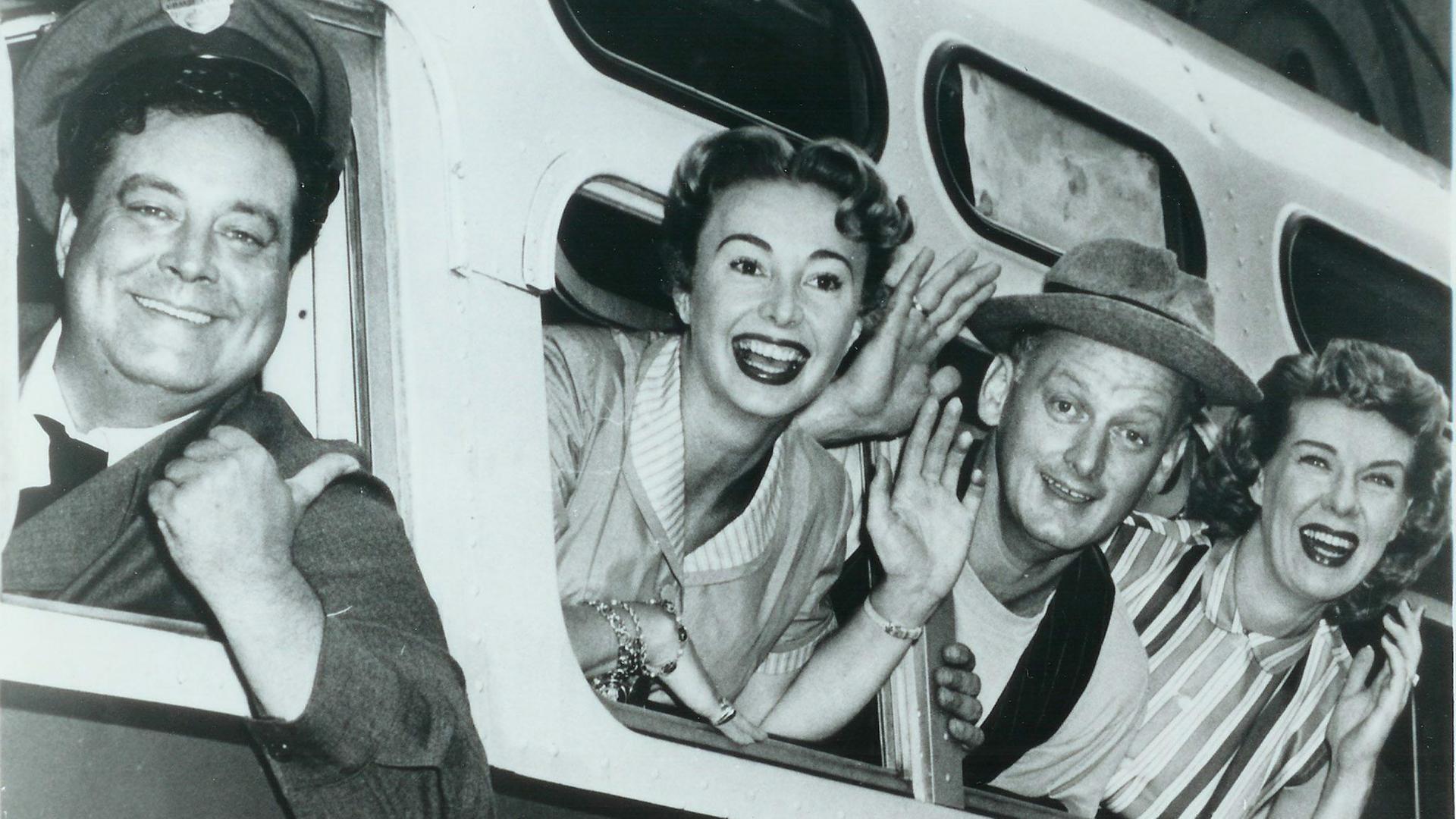 Die Hauptpersonen der Sitcim "The Honeymooners" winken aus einem Zug. Von links: Jackie Gleason , Audrey Meadows, Art Carney und Joyce Randolph. Die Hauptpersonen der Sitcim "The Honeymooners" winken aus einem Zug. Von links: Jackie Gleason , Audrey Meadows, Art Carney und Joyce Randolph.