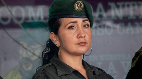Frau mit schwarzen Haaren, einer Armeemütze mit dem Bild von Che Guevara und einer Armeejacke