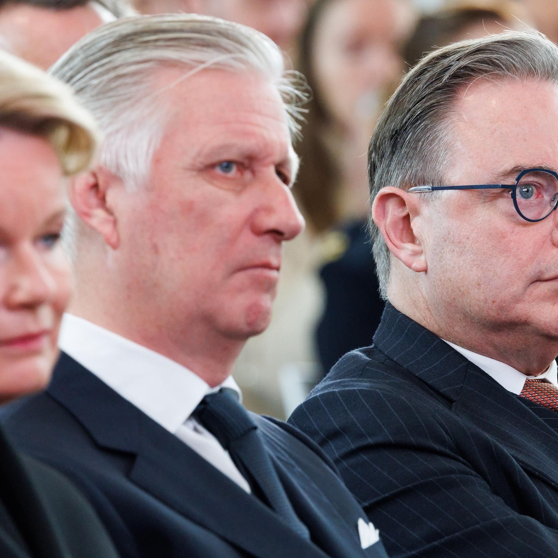 Zu sehen sind das belgische Königspaar und Premierminister De Wever bei einer Veranstaltung.
