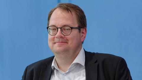 Sören Pellmann bei der Vorstellung des Jahresberichts des Petitionsausschusses des Bundestags am 26. Juni 2024. Er trägt eine Brille, hat das helle Hemd einen Knopf offen unterm dunklen Sakko.
