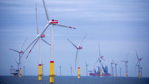 Ein Arbeitsschiff steht auf Stelzen zwischen den Windrädern die in der Ostsee. Im Vordergrund ist der Windpark "Arkona" etwa 35 Kilometer nordöstlich von Rügen zu sehen. Im Hintergrund die Offshore-Windkraftanlagen des Ostsee-Windpark "Wikinger"