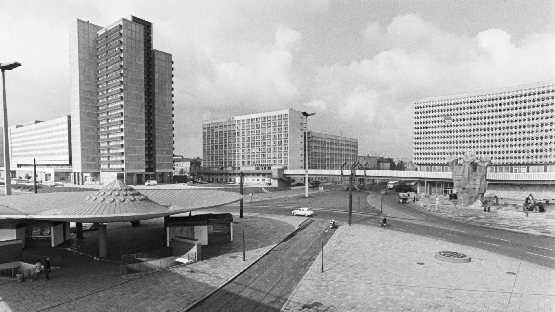 Schwarz-weiße Architekturaufnahme eines modernen Platzes, der von Hochhäusern umgeben ist