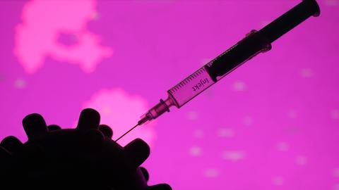 Die Illustration zeigt eine Spritze, die in einem Corona-Virus steckt.