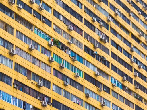Mehrere Klimaanlagen hängen an der Außenfassade eines Wohngebäcks in Singapur Mehrere Klimaanlagen hängen an der Außenfassade eines Wohngebäcks in Singapur
