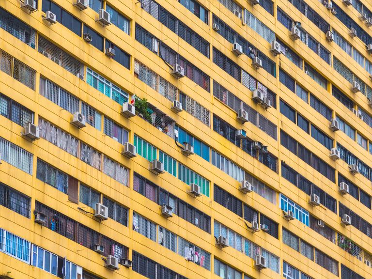 Mehrere Klimaanlagen hängen an der Außenfassade eines Wohngebäcks in Singapur Mehrere Klimaanlagen hängen an der Außenfassade eines Wohngebäcks in Singapur