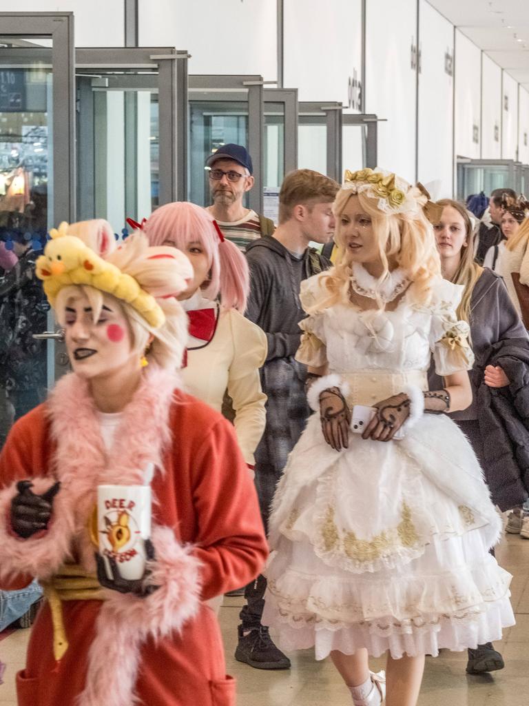 Ein Messegang mit vielen Menschen, manche von Ihnen sind verkleidet.