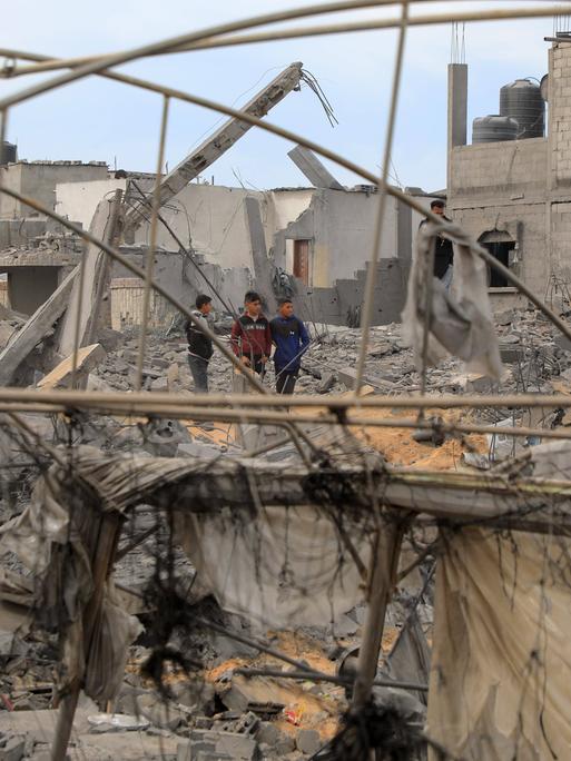 Palästinenser sind zwischen den Trümmern nach israelischen Luftangriffen im südlichen Gazastreifen in der Stadt Rafah zu sehen.