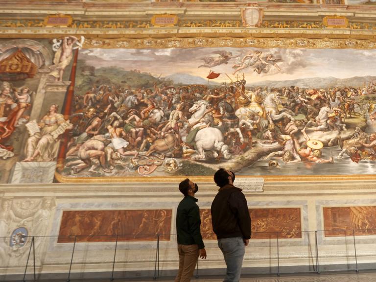 VATICAN, VATICAN CITY, MAY 03: Tourists admire one of the Raphael Rooms, ahead of the re-opening of the Vatican Museums, at the Vatican City, on May 03, 2021. The re-opening follows the third closure of the Museums since the start of the COVID-19 pandemic, with more stringent rules, including obligatory bookings, punctuality in turning up, protective masks, and social distancing. Riccardo De Luca / Anadolu Agency
