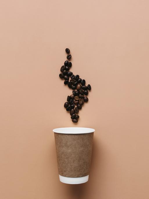 Illustration: Ein Kaffeebecher mit Dampf aus Kaffebohnen.