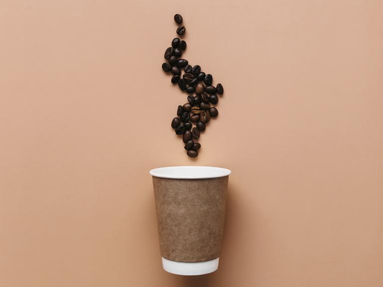 Illustration: Ein Kaffeebecher mit Dampf aus Kaffebohnen.