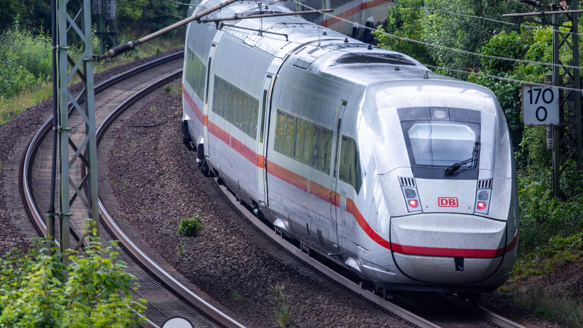 Ein ICE-Zug fährt auf Gleisen.