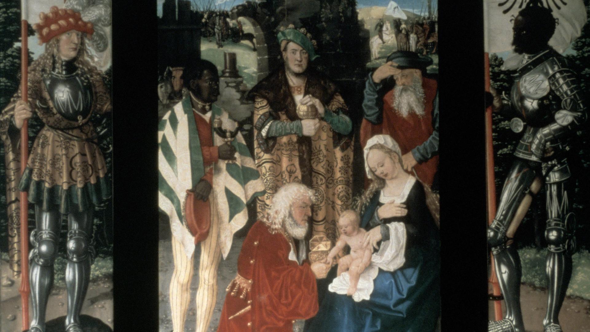 Hans Baldung-Griens Tryptichon "Anbetung der Heiligen drei Könige" zeigt mittig die heiligen drei Könige, davor kniet ein bärtiger Mann vor Maria, die das Jesuskind auf dem Schoß hält.