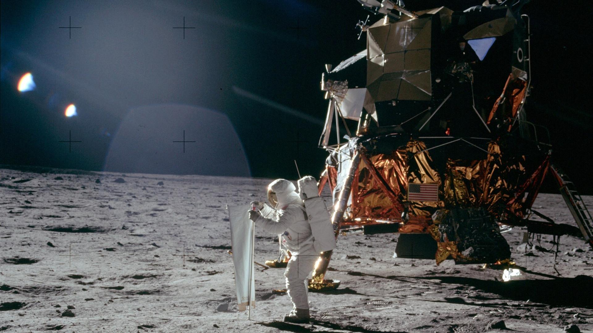 Apollo-11-Astronaut Buzz Aldrin beim Aufstellen der „Schweizer Flagge“ auf dem Mond Apollo-11-Astronaut Buzz Aldrin beim Aufstellen der „Schweizer Flagge“ auf dem Mond