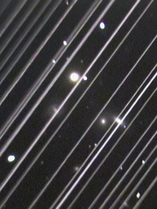 An image of the NGC 5353/4 galaxy group made with a telescope at Lowell Observatory in Arizona, USA on the night of Saturday 25 May 2019. The diagonal lines running across the image are trails of reflected light left by more than 25 of the 60 recently launched Starlink satellites as they passed through the telescopeâs field of view. Although this image serves as an illustration of the impact of reflections from satellite constellations, please note that the density of these satellites is significantly higher in the days after launch (as seen here) and also that the satellites will diminish in brightness as they reach their final orbital altitude.