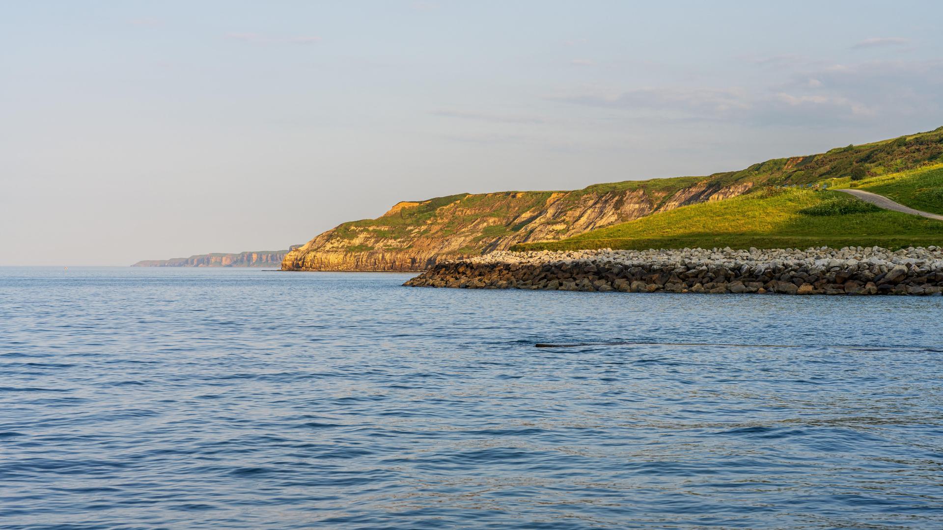 Ein Blick über die Nordseeküste und die Klippen am South Bay Beach in Scarborough, North Yorkshire, England Ein Blick über die Nordseeküste und die Klippen am South Bay Beach in Scarborough, North Yorkshire, England