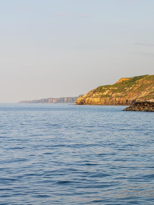 Ein Blick über die Nordseeküste und die Klippen am South Bay Beach in Scarborough, North Yorkshire, England