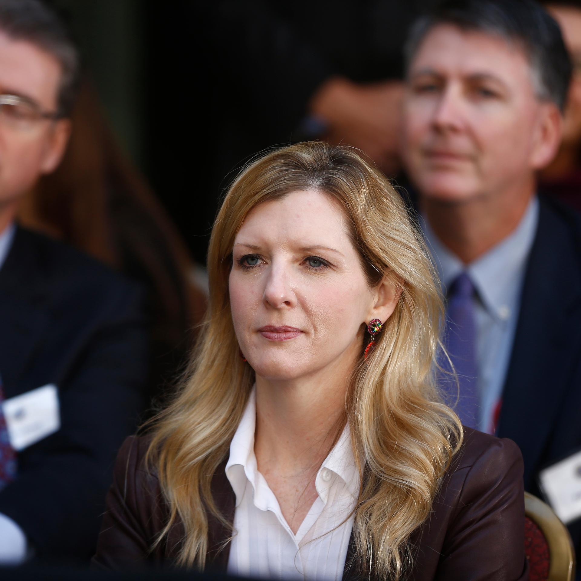 Kathryn Ruemmler im Porträt, hinter ihr noch zwei verschwommene Personen