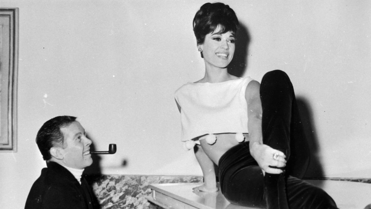 Die Schauspielerin Claudia Cardinale sitzt in einer Szene aus dem Film "Der rosarote Panther" auf einem Klavier.
