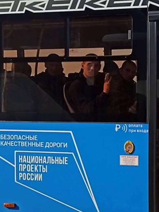 Russische Soldaten in einem blauen Bus nach einen Gefangenenaustuasch mit der Ukraine.