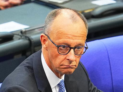 Der designierte Bundeskanzler Friedrich Merz (CDU) schaut enttäuscht, nachdem er bei der Kanzlerwahl im Bundestag nicht die notwendige Mehrheit erhalten hat.