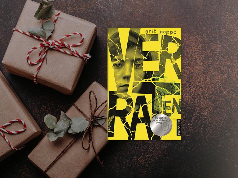 Cover des Buchs Verraten von Grit Poppe neben weihnachtlichen Päckchen.
