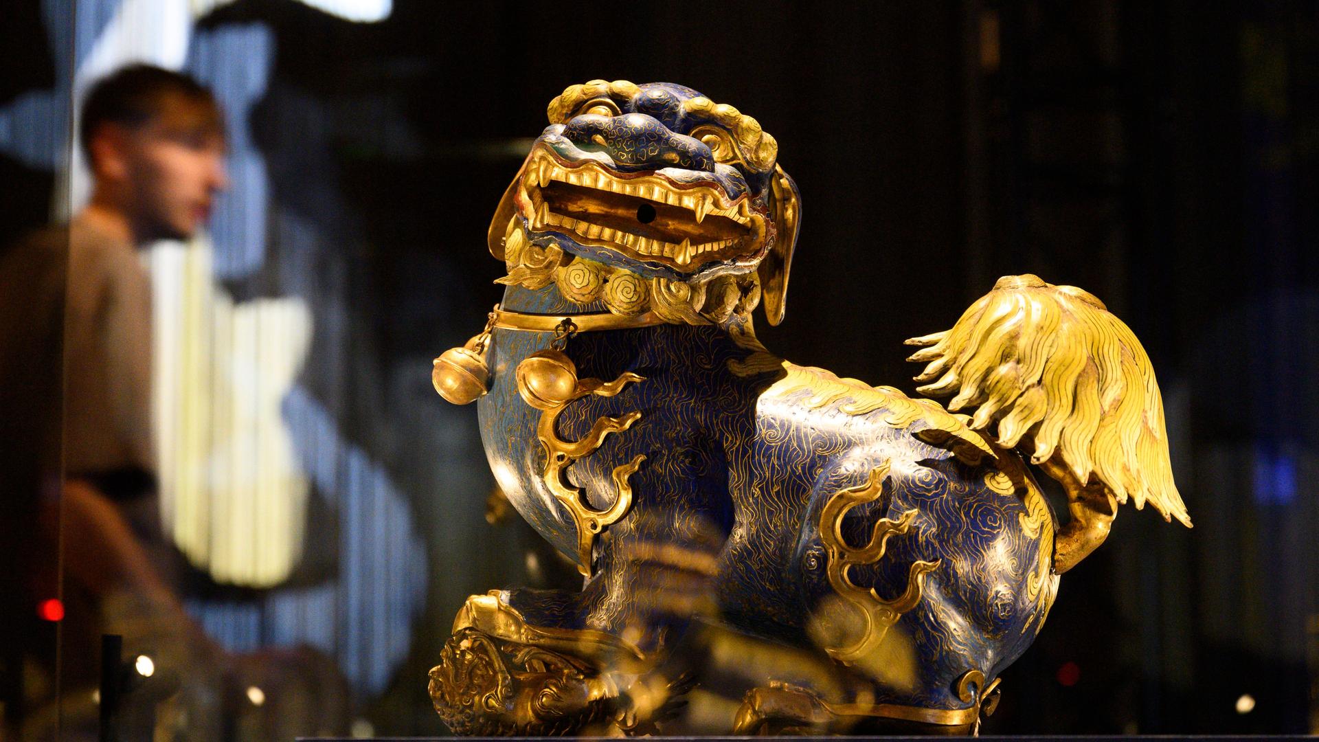 Eine bunt bemalte Fanatsiefigur mit breitem Maul und großen Augen.