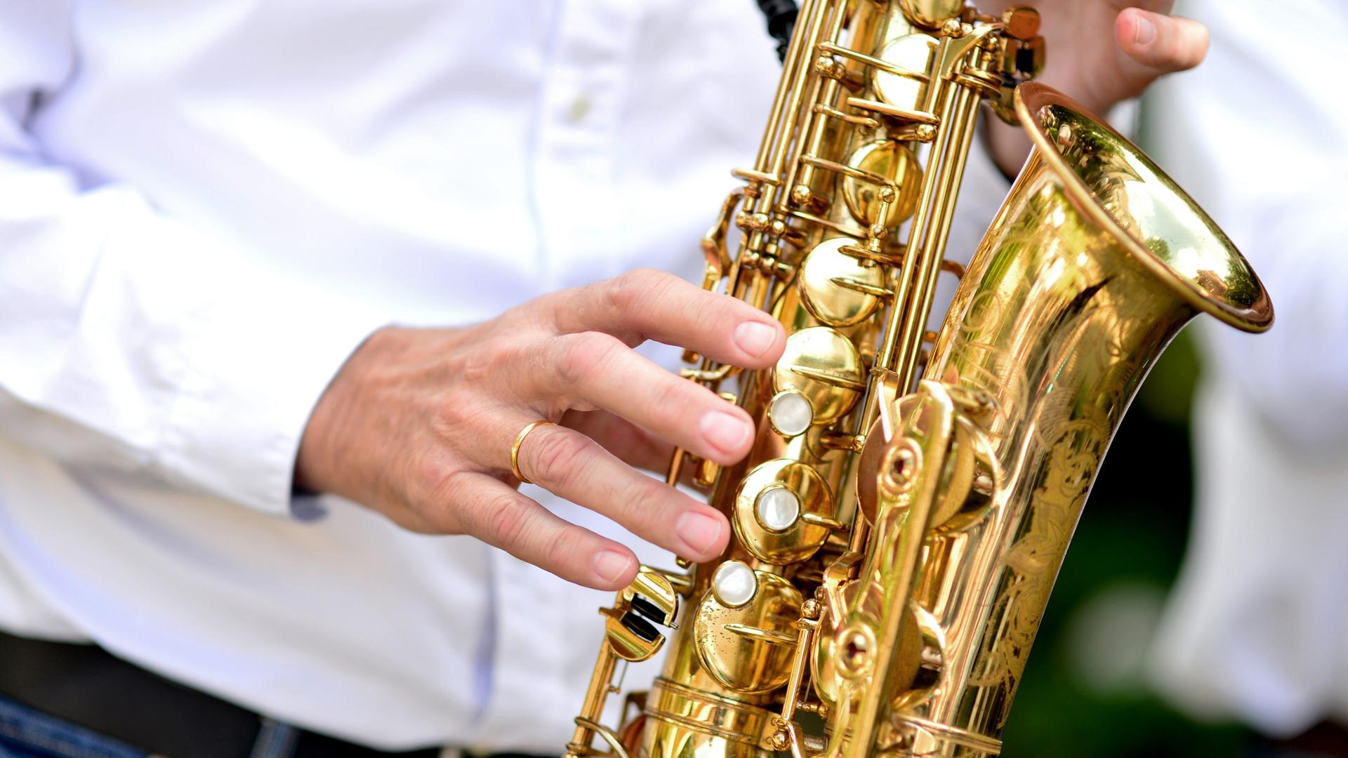 Ein Musiker spielt auf einem Saxophon.