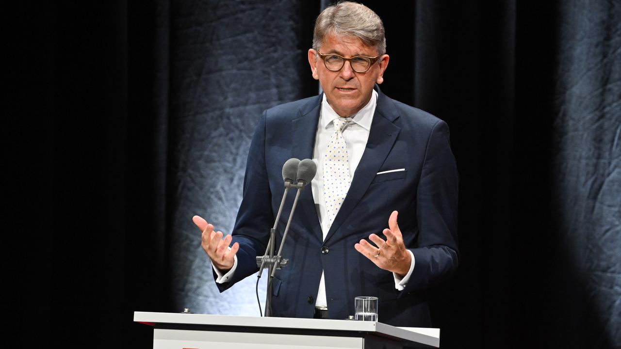 Kulturstaatsminister Wolfram Weimer steht gestikulierend hinter einem Rednerpult mit der Aufschrift Frankfurter Buchmesse.