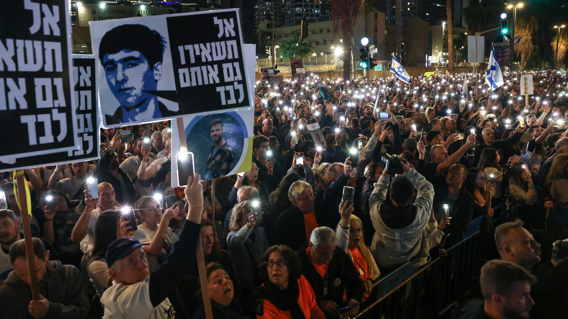 In Tel Aviv fordern Demonstranten die Freilassung aller Geiseln. Sie halten Plakate mit den Bildern von Verschleppten hoch. In Tel Aviv fordern Demonstranten die Freilassung aller Geiseln. Sie halten Plakate mit den Bildern von Verschleppten hoch.
