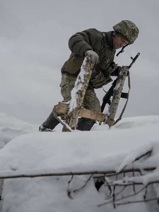 Ein ukrainischer Soldat mitten im Schnee bei Kupiansk. 
